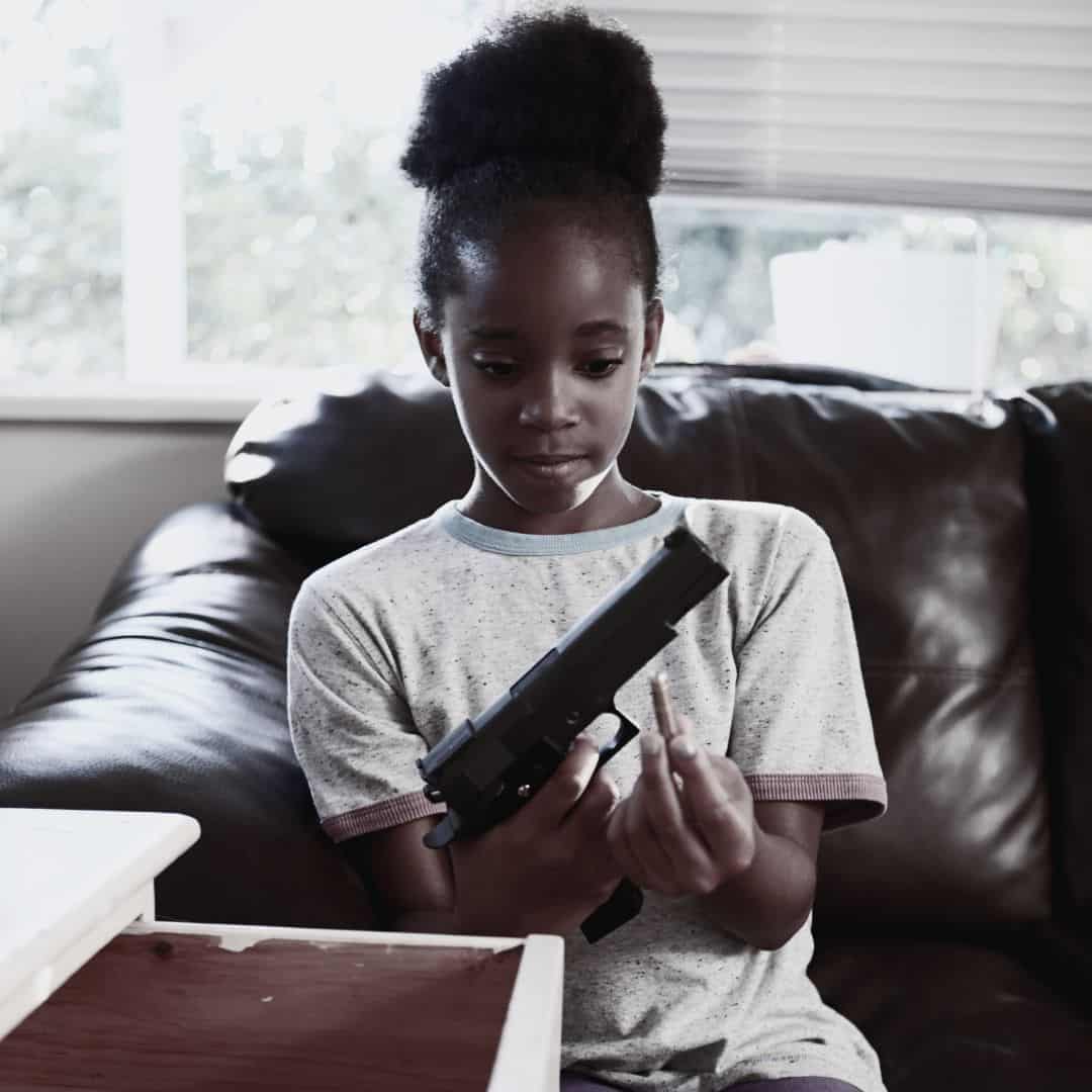 Girl discovering gun in dresser.
